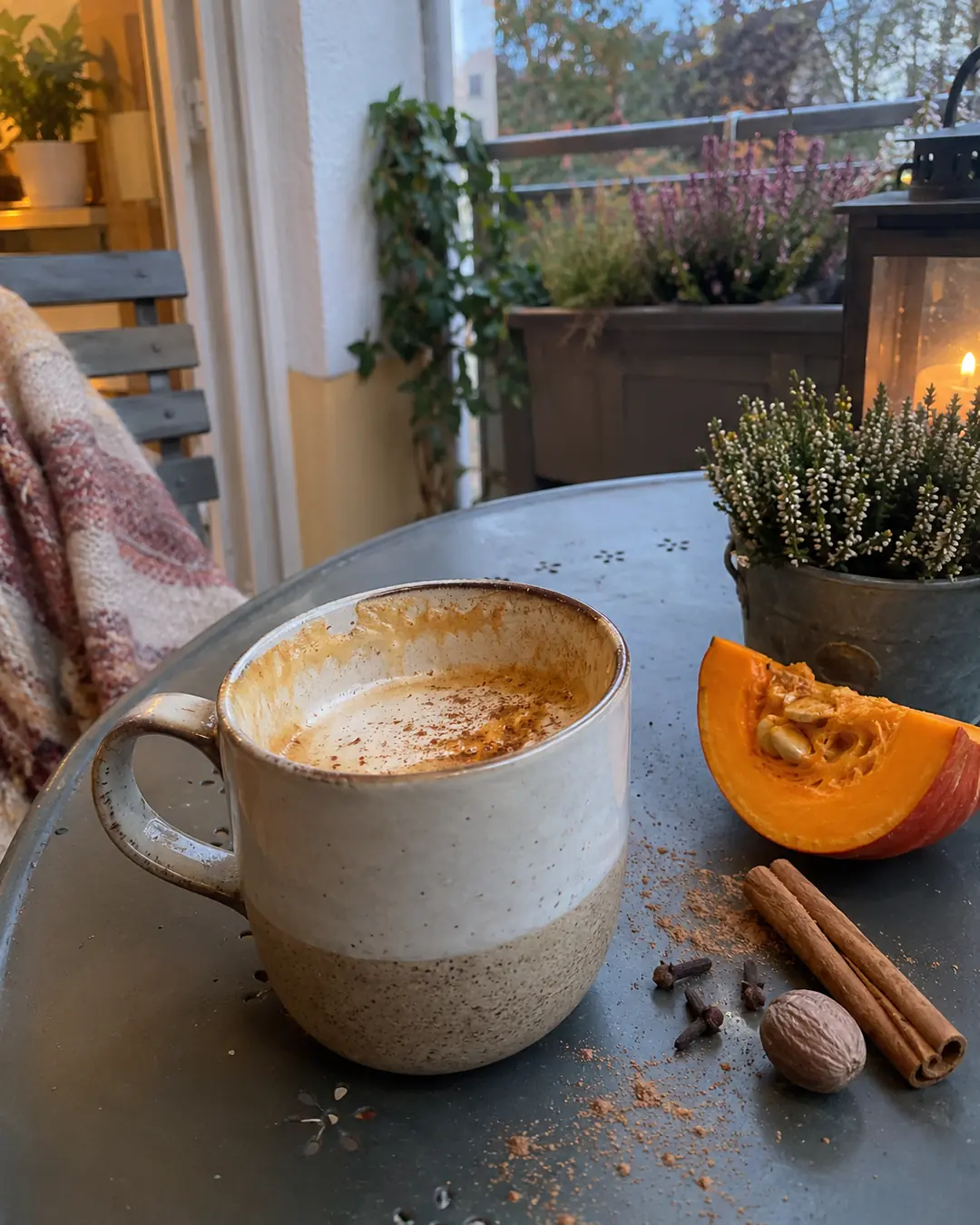 Tasse Pumpkin Spice Latte mit echtem Kürbispüree und aufgeschäumtem Haferdrink, mit Zimt bestreut